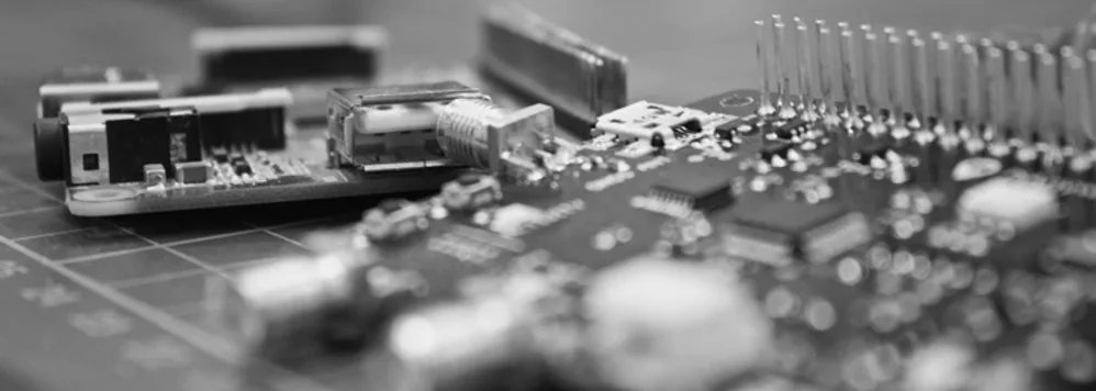 Close-up of a circuit board with a USB port and surface-mounted components