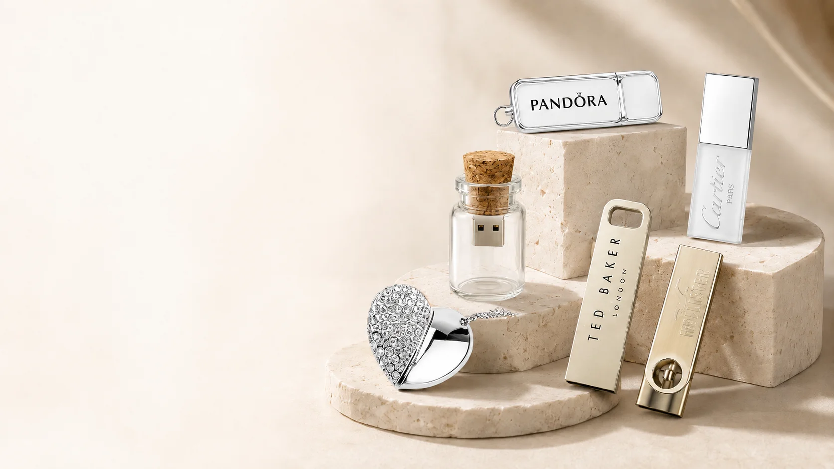 Luxury branded USB drives including crystal heart and glass bottle styles on a stone display